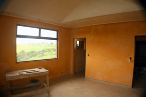 The master bedroom is a large bright room with a lake view.